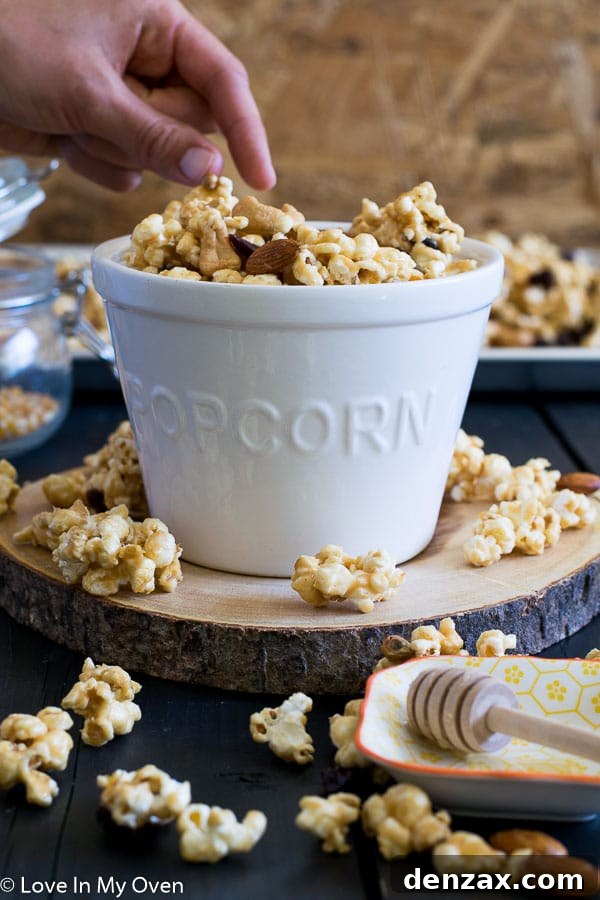 Hand reaching for Trail Mix Popcorn