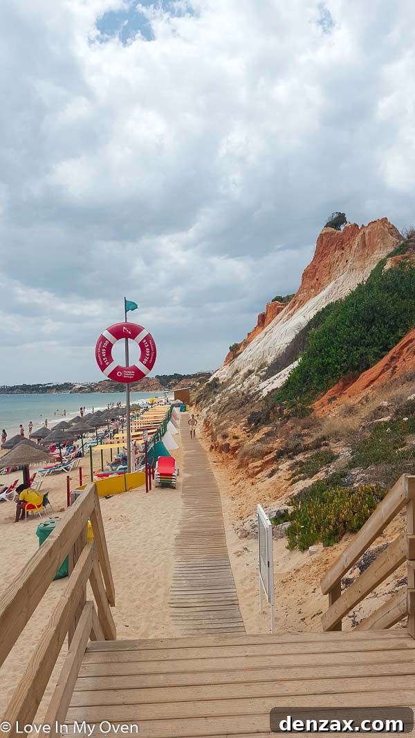 Stunning red rocky cliffs and golden beach in Algarve