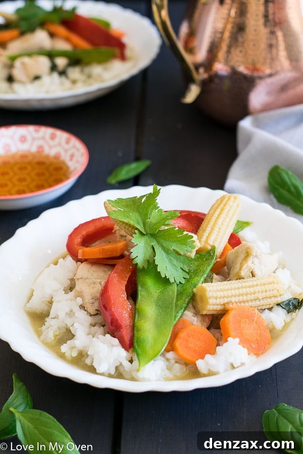 Thai Green Chicken Curry with rice and fresh basil garnish
