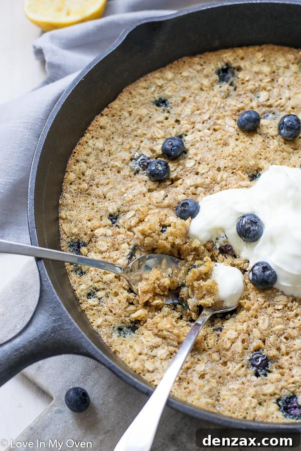 Blueberry breakfast cookie cooling in a skillet, ready to be served
