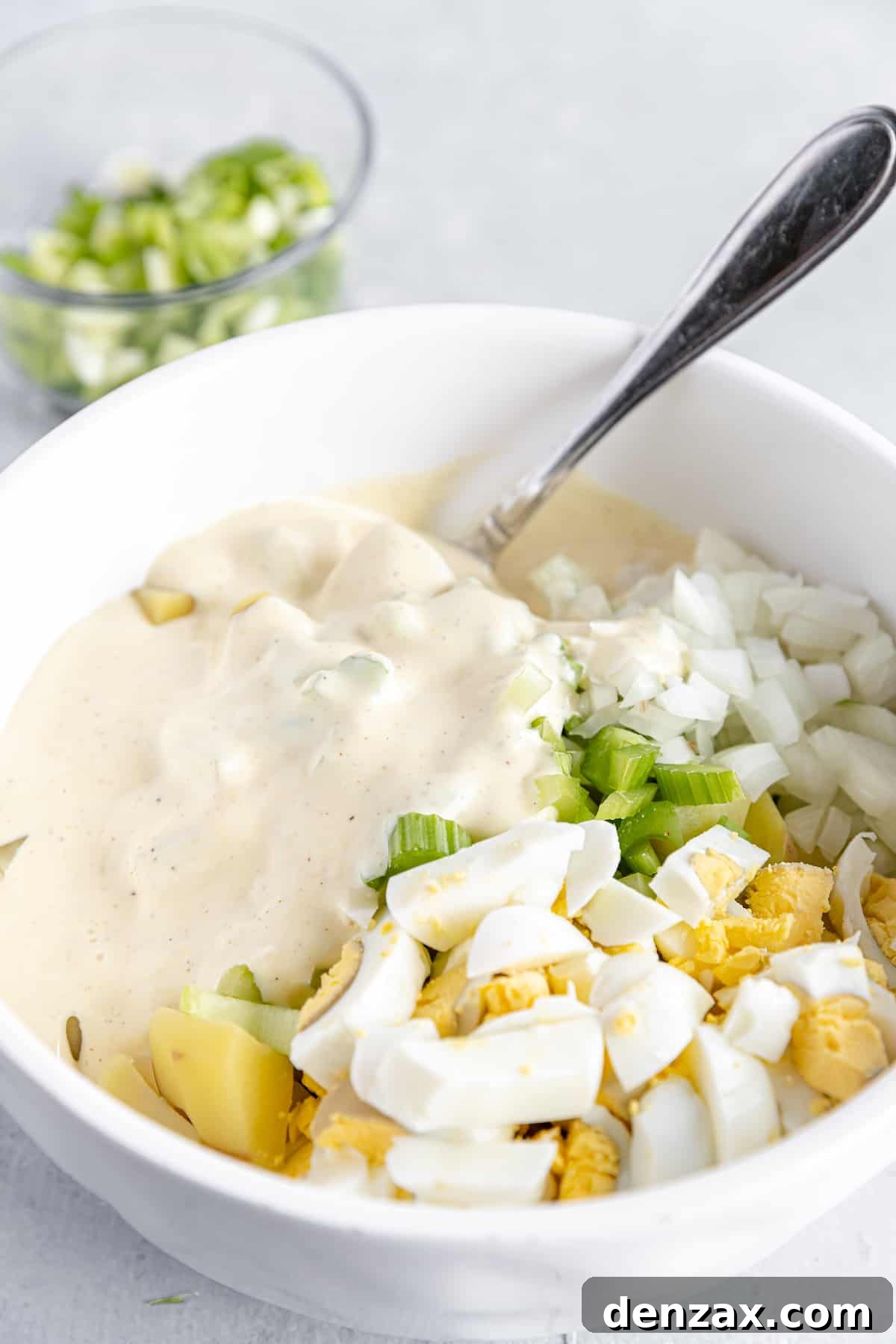 Mayonnaise Dressing Added Into the Bowl of Unmixed Potato Salad Ingredients