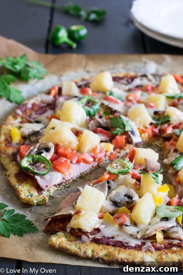 Delicious gluten-free zucchini pizza with fresh toppings, ready to eat.