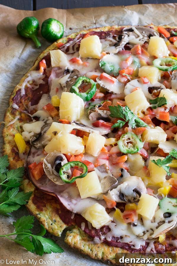 Close-up of a slice of gluten-free zucchini pizza, showing the crust and fresh toppings.
