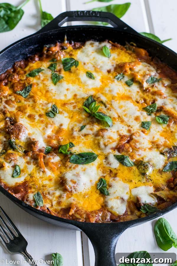 Close-up of the broiled cheese topping on the skillet linguine, showing golden and bubbly texture.