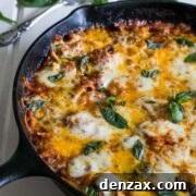One-pan skillet pasta with meat and vegetables, topped with melted cheese.