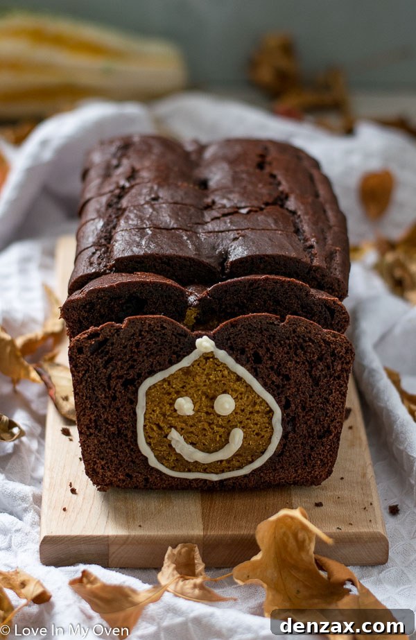 Close-up of a slice of Pumpkin Chocolate Loaf with a defined pumpkin shape inside