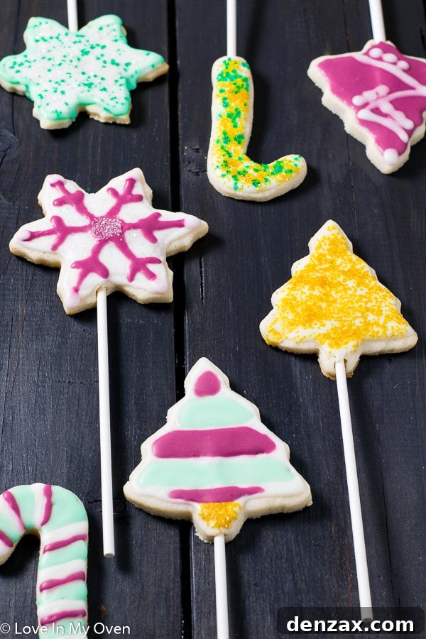 Festive Cookie Pop Treats 5 Decorated vanilla bean cookie pops on a rustic wooden serving platter