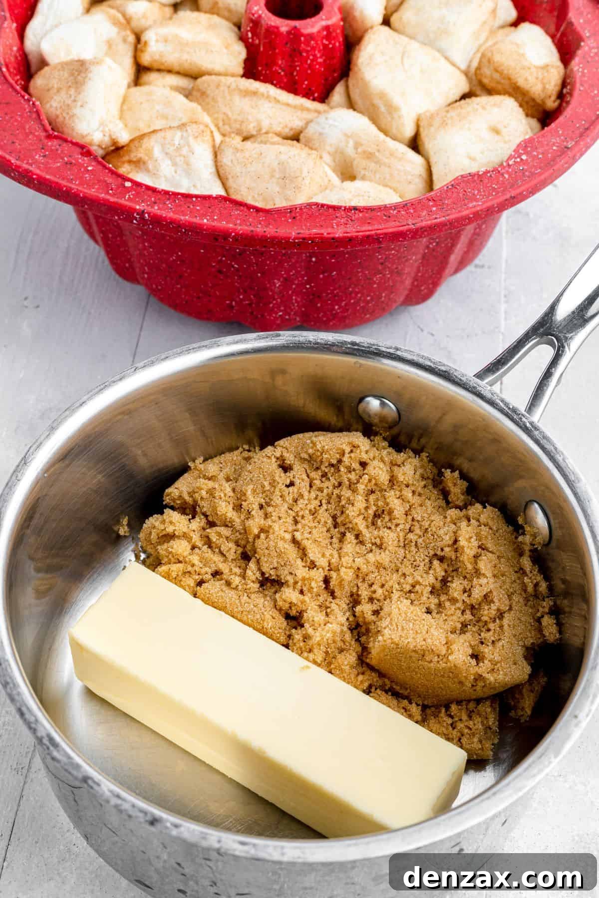 Irresistible Pull-Apart Loaf 4 A Bundt pan filled with biscuit dough pieces sits on a counter next to a saucepan containing melting butter and brown sugar.