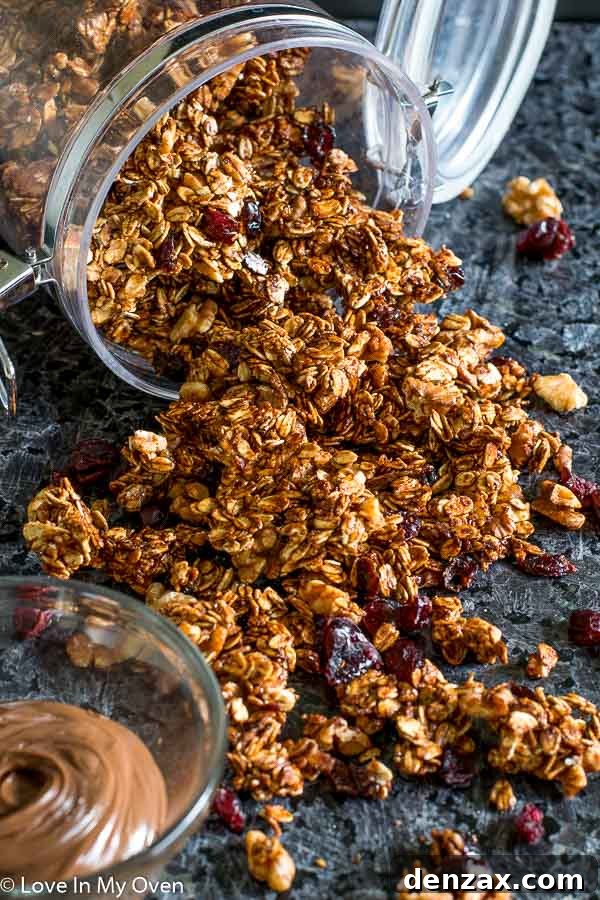 Nutella Walnut Granola spread on a baking sheet, ready for the oven