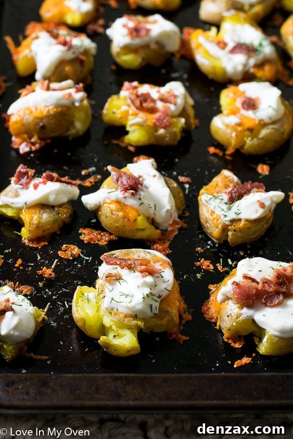 Multiple loaded smashed potatoes on a serving tray