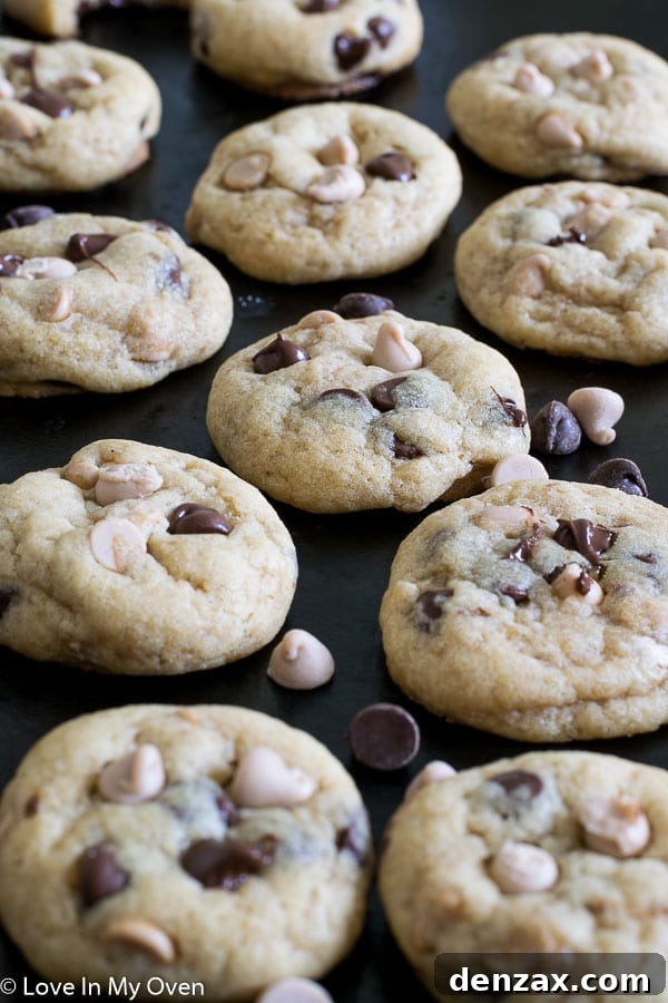 A stack of perfectly baked sea salt caramel chocolate chip cookies, showing their soft centers