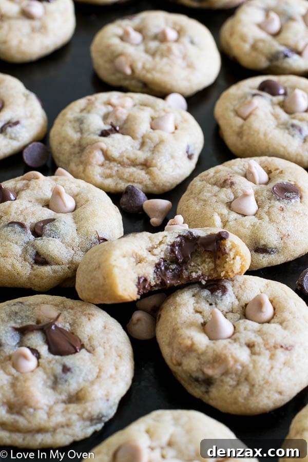 Two sea salt caramel chocolate chip cookies placed on a white surface, highlighting their texture