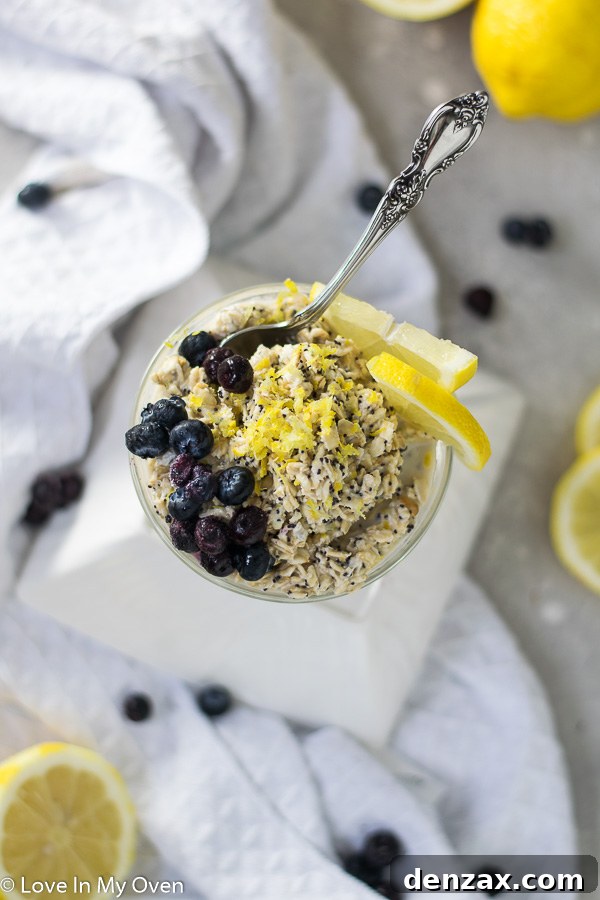 Overhead view of lemon poppy seed overnight oats garnished with fresh lemon slices and poppy seeds.