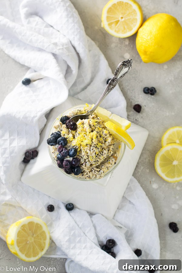Two jars of lemon poppy seed overnight oats, one garnished with blueberries and lemon slices.