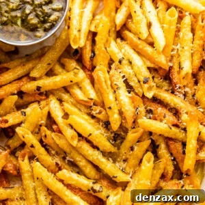 close up of baked pasta chips served with basil pesto
