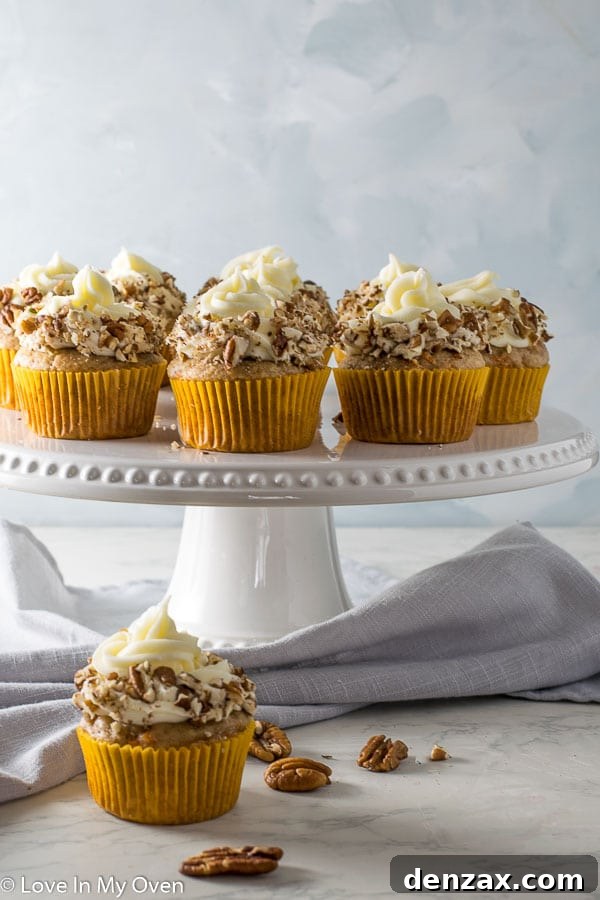 A festive display of carrot cake cupcakes, perfect for an Easter celebration, with decorative elements.