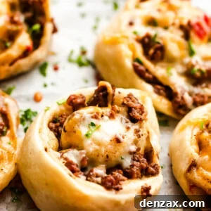 Cooked taco pinwheels on a baking sheet, ready for serving.