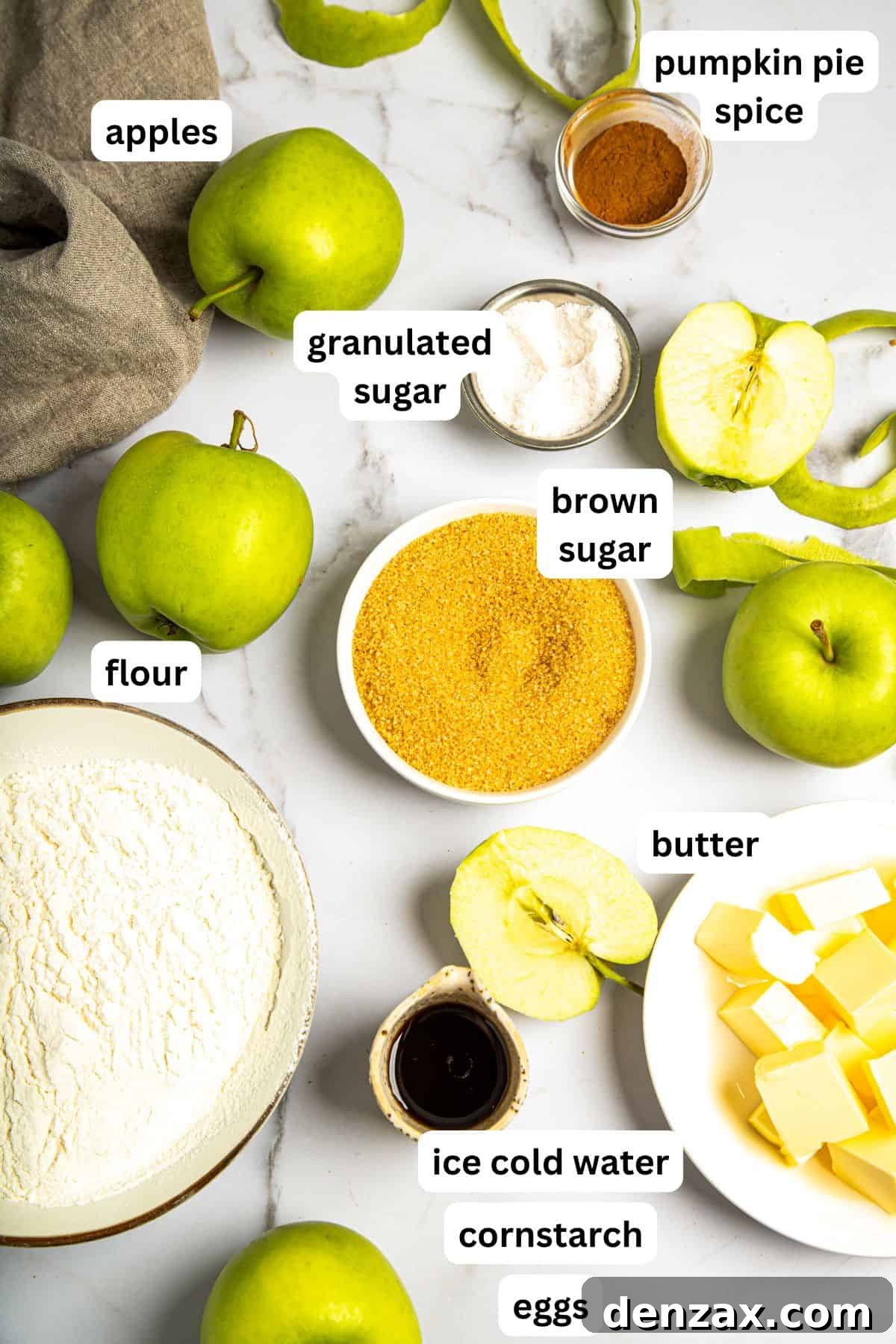 An image showing all the essential ingredients laid out for making a homemade apple pie from scratch, including apples, flour, butter, sugar, and spices.
