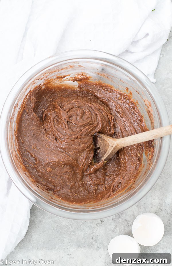 A toothpick being inserted into the center of a baked skillet brownie to check for doneness.