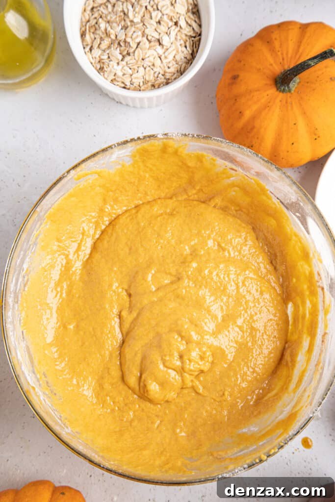 Close-up of the smooth, spiced pumpkin muffin batter in a mixing bowl, ready for baking.