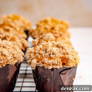 Freshly baked pumpkin muffins cooling on a wire rack, ready to be enjoyed.
