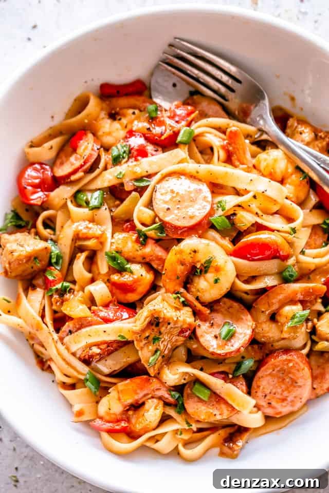 A second view of the delectable One Pot Jambalaya Pasta, showcasing the rich sauce and perfectly cooked ingredients in a white bowl.
