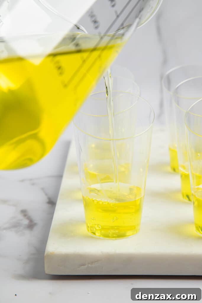Lemon jello poured into shot glasses.
