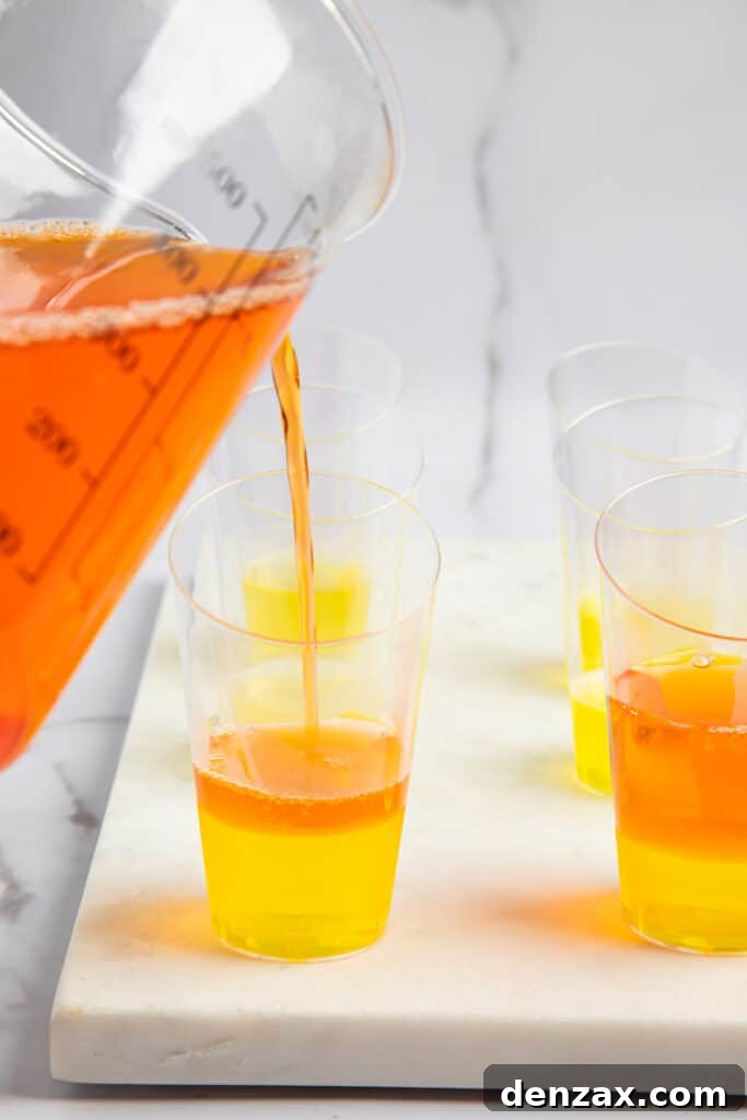 Orange jello added to shot glasses with lemon jello at the bottom.