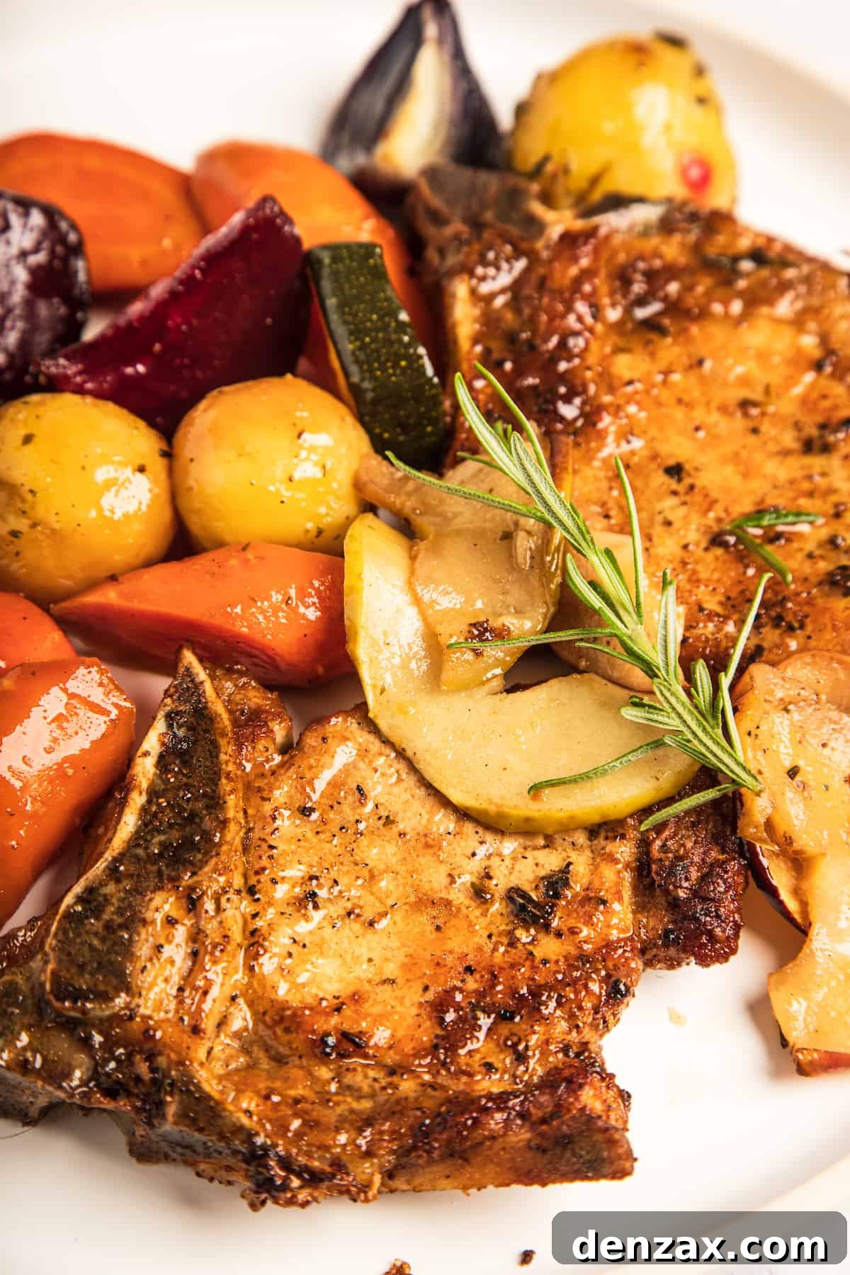 A close-up shot of the pork chops and mixed vegetables.