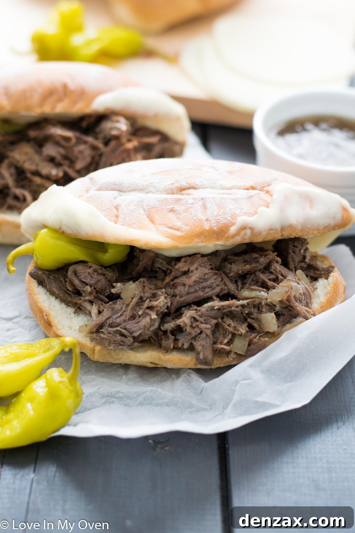 Close-up of shredded Italian beef in a slow cooker, infused with rich broth and spices.