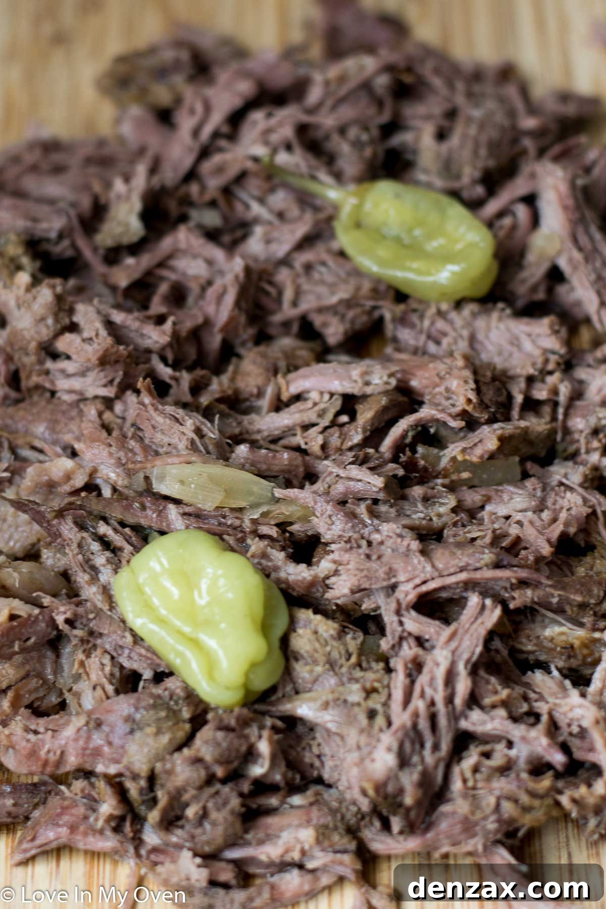 Beef chuck roast nestled in a slow cooker with onions and spices, beginning to cook.