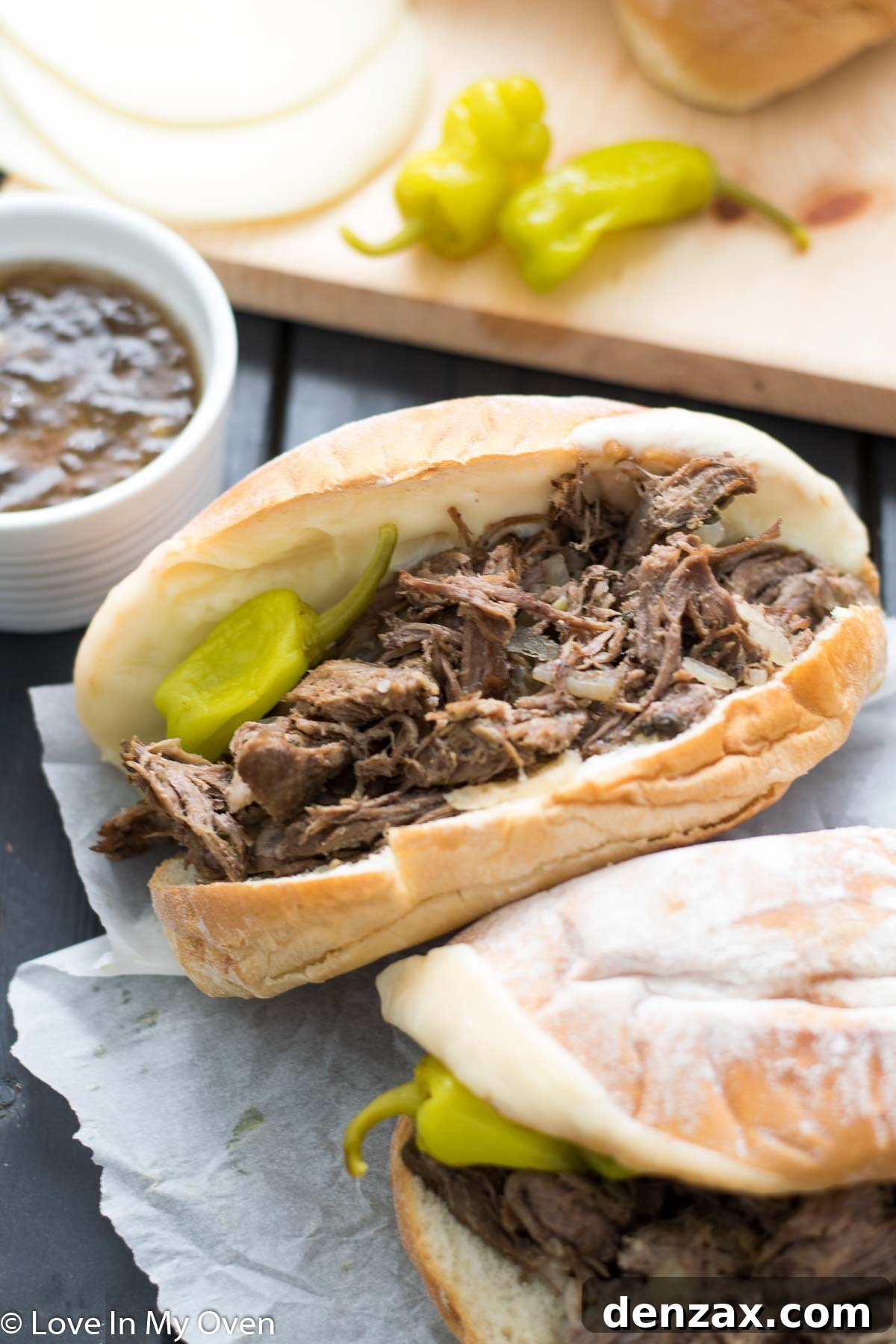 Several Italian beef sandwiches arranged on a platter, showcasing the tender meat and cheesy rolls.