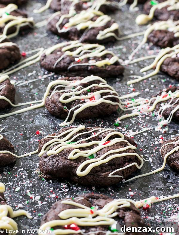 A festive stack of Mint Chocolate Candy Cane Cookies with white chocolate drizzle.