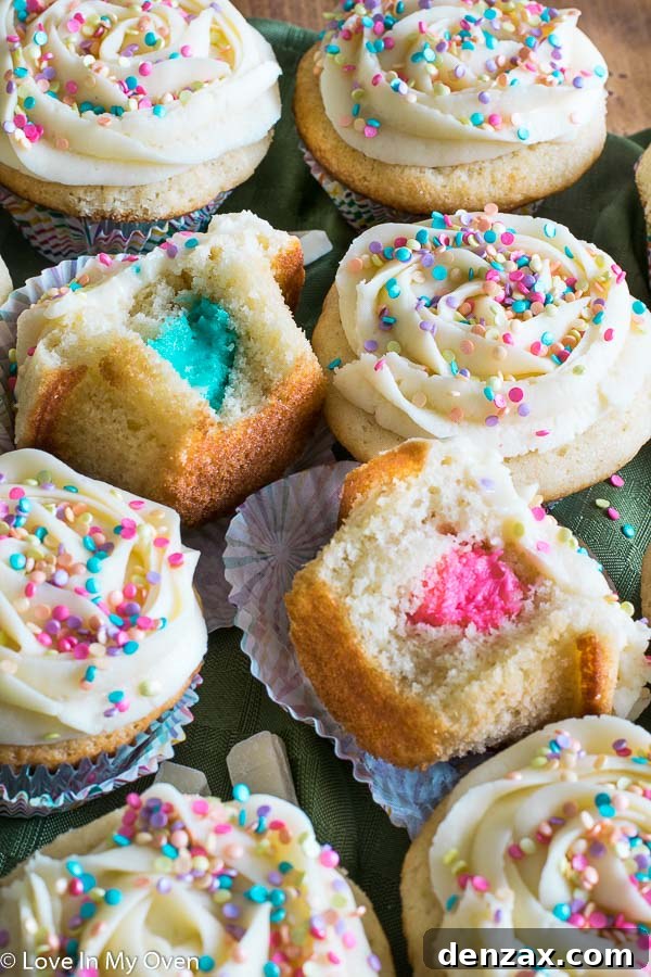 Festive Gender Reveal Cupcakes revealing pink or blue filling.
