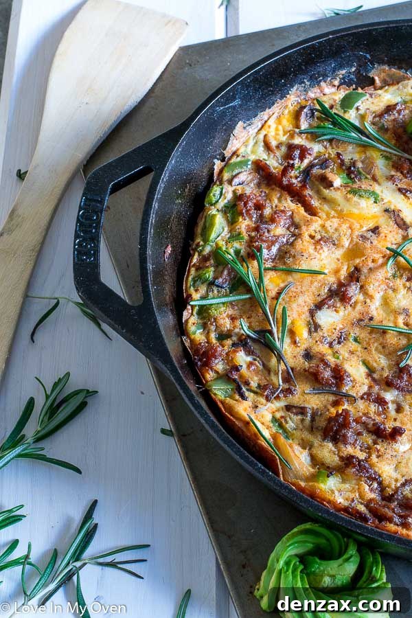 Individual serving of Keto Chorizo Frittata garnished with fresh avocado slices.