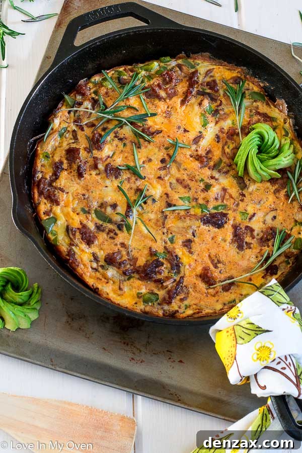 A whole Keto Chorizo Frittata in a cast-iron skillet, ready to be served.