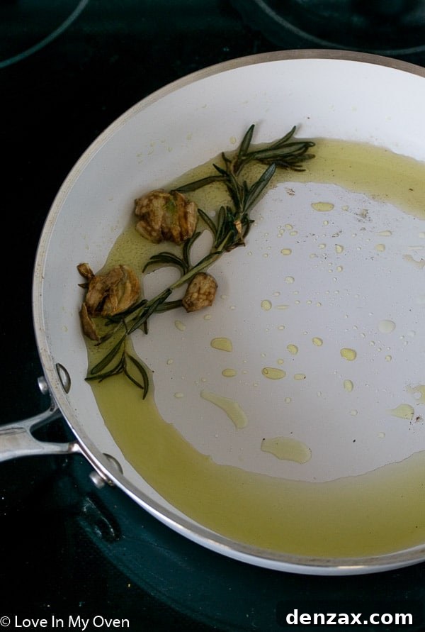 Ingredients for Parmesan Rosemary Popcorn including fresh rosemary, garlic, and Parmesan cheese