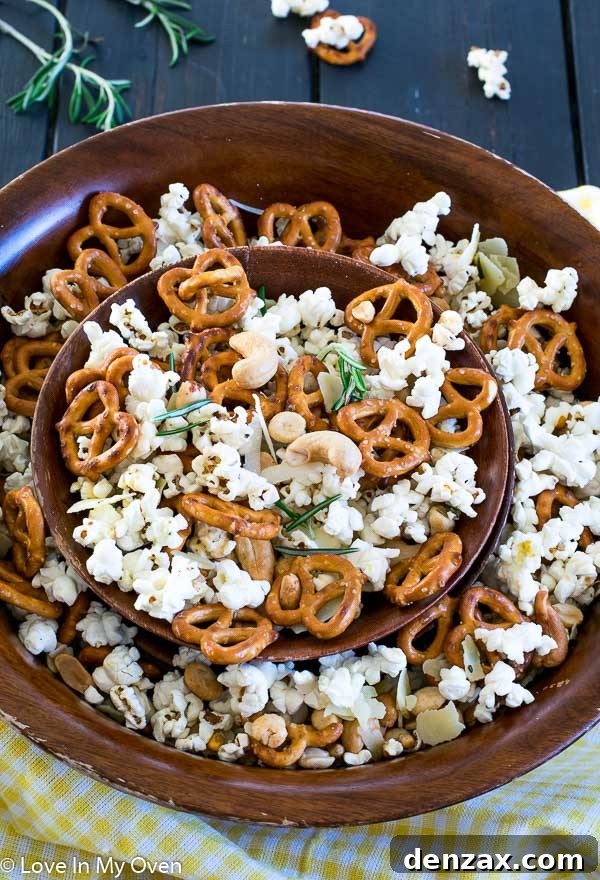 Hand reaching for a handful of Parmesan Rosemary Popcorn