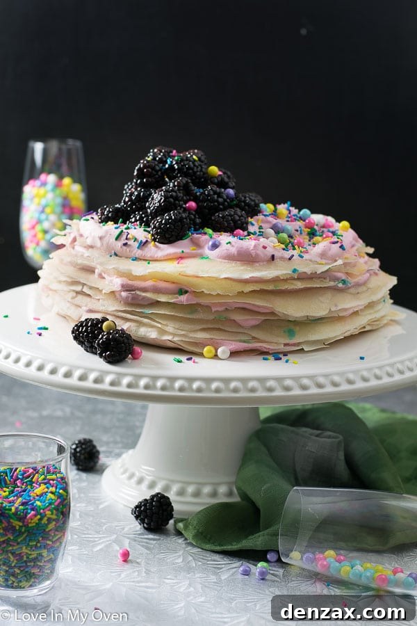 Funfetti Crepe Cake with colorful sprinkles on a cake stand, ready to be served