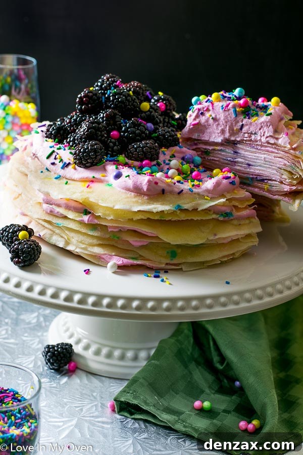 Close-up of Funfetti Crepe Cake topped with whipped cream and colorful sprinkles