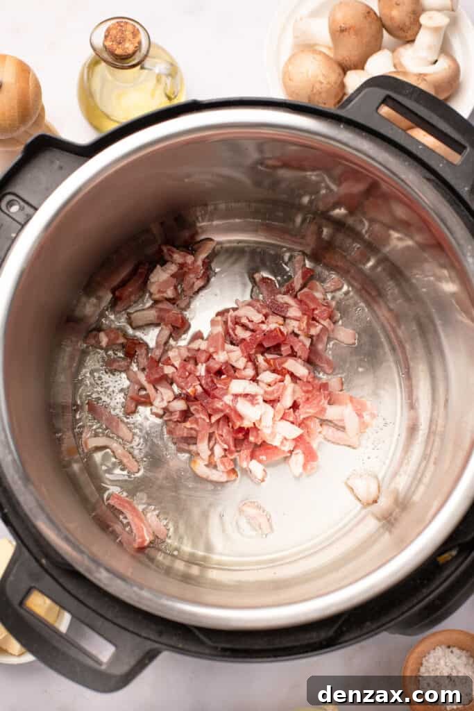 Diced bacon frying in an Instant Pot.
