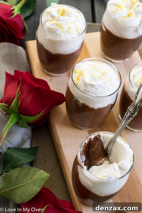 A festive table setting with a heart-shaped chocolate cake and other Valentine's Day treats, emphasizing warmth and celebration.