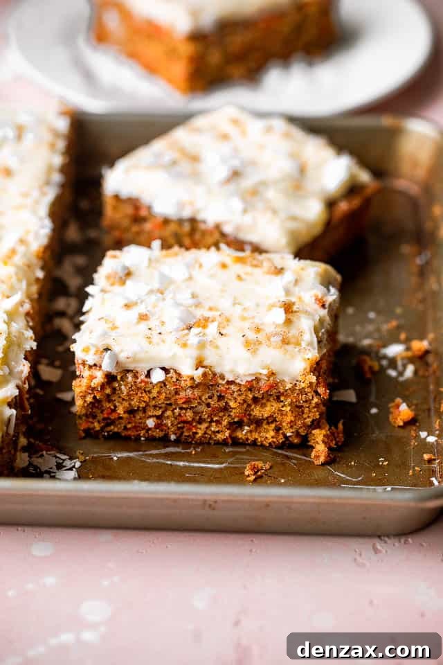 Multiple slices of frosted carrot cake on a serving platter