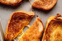 Crispy Baked Grilled-Cheese Sandwiches with Golden Cheddar