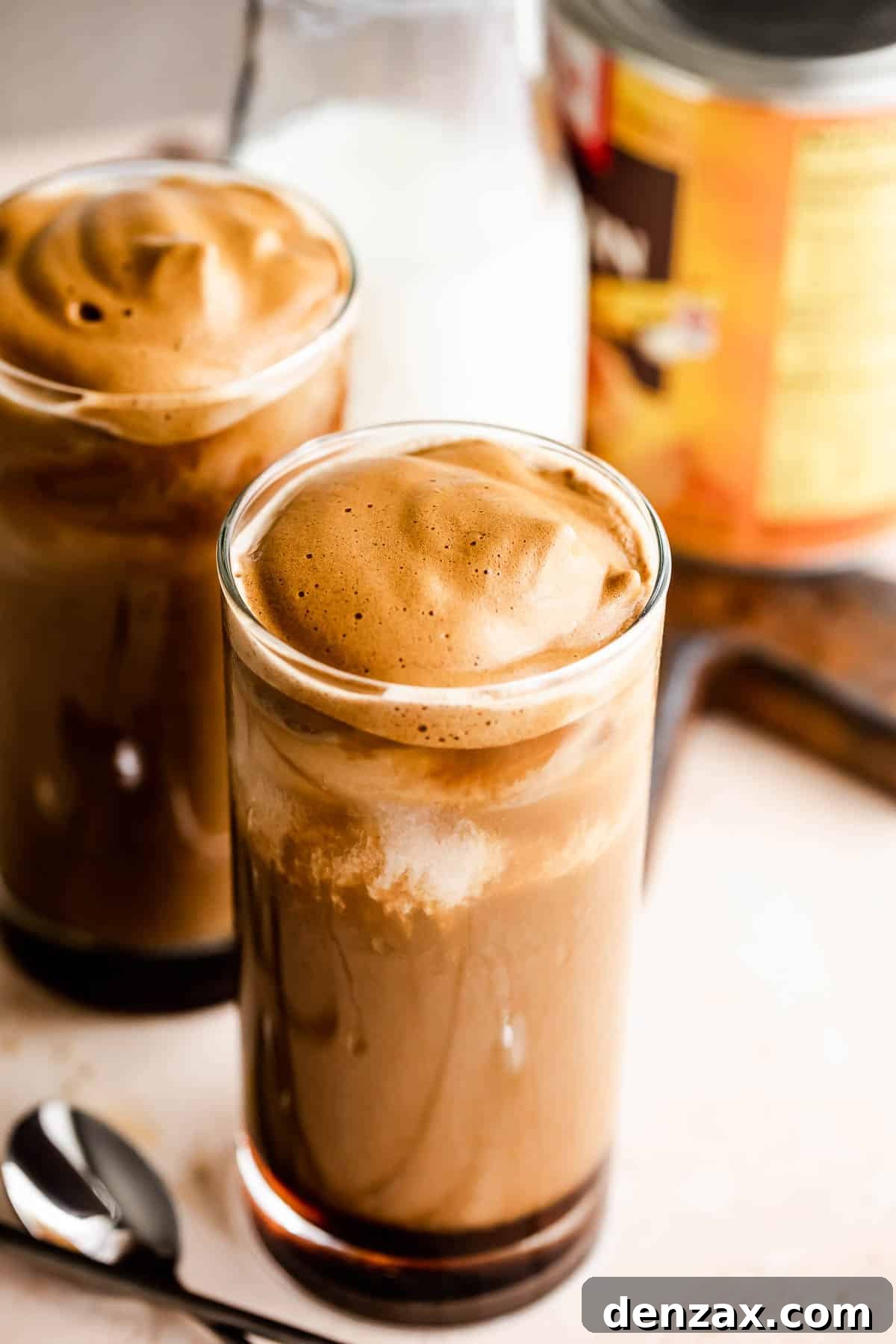 Pumpkin Cream Cold Brew served in two drinking glasses with a pumpkin can placed right beside them.