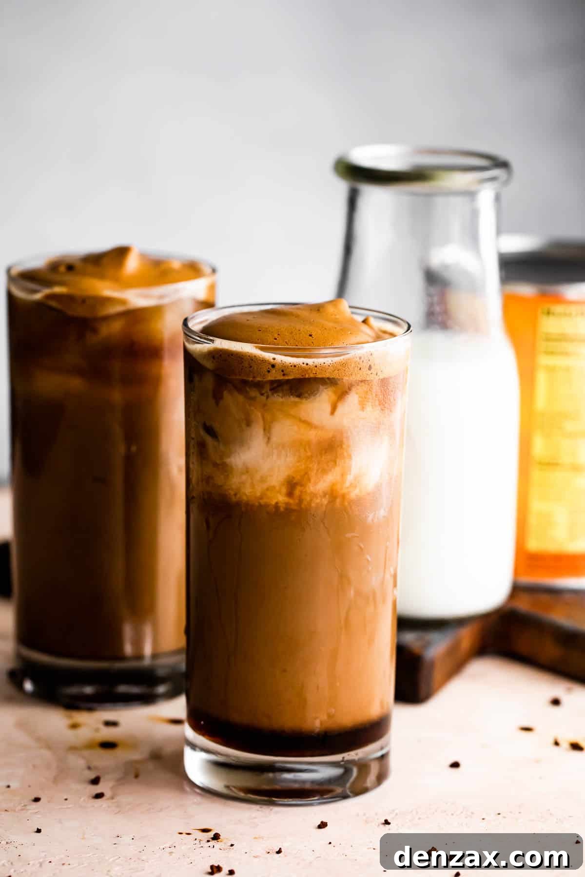 Pumpkin Cream Cold Brew served in two drinking glasses with a milk bottle placed right beside them.