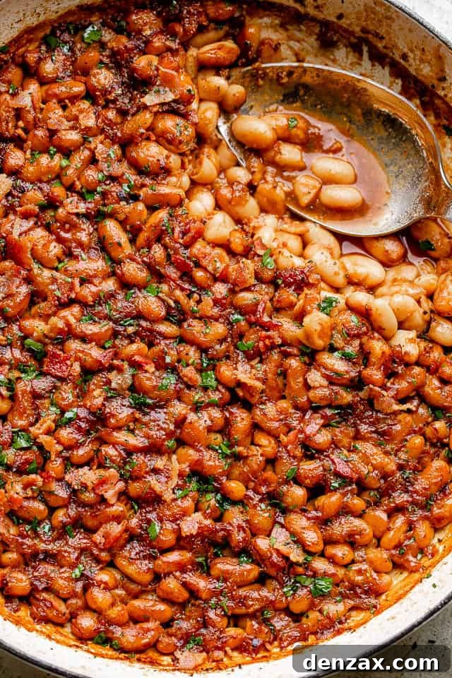 These homemade baked beans are like nothing you’ve ever tried before! Sweet, tang, and a little spicy. Don’t miss the surprise - ROOT BEER! Pot of homemade maple bacon baked beans.