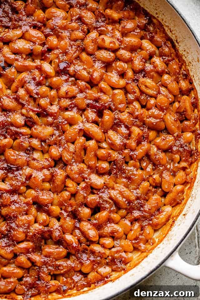 These homemade baked beans are like nothing you’ve ever tried before! Sweet, tang, and a little spicy. Don’t miss the surprise - ROOT BEER! pot of baked beans topped with bacon