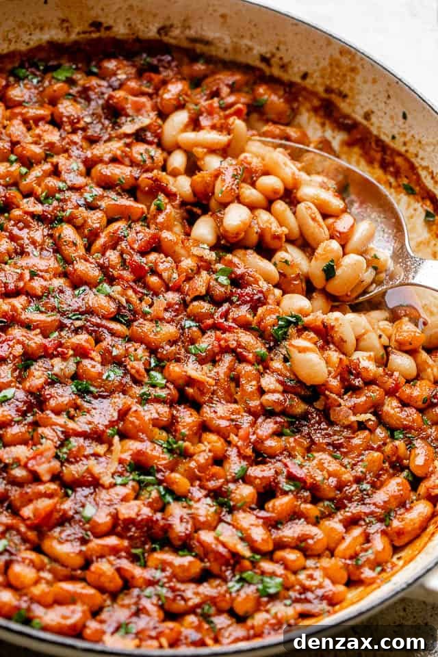 Scoop and serve these maple bacon baked beans scooping out baked beans from a pot