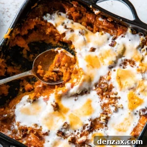 Sweet potato casserole with a spoon scooping out a portion.